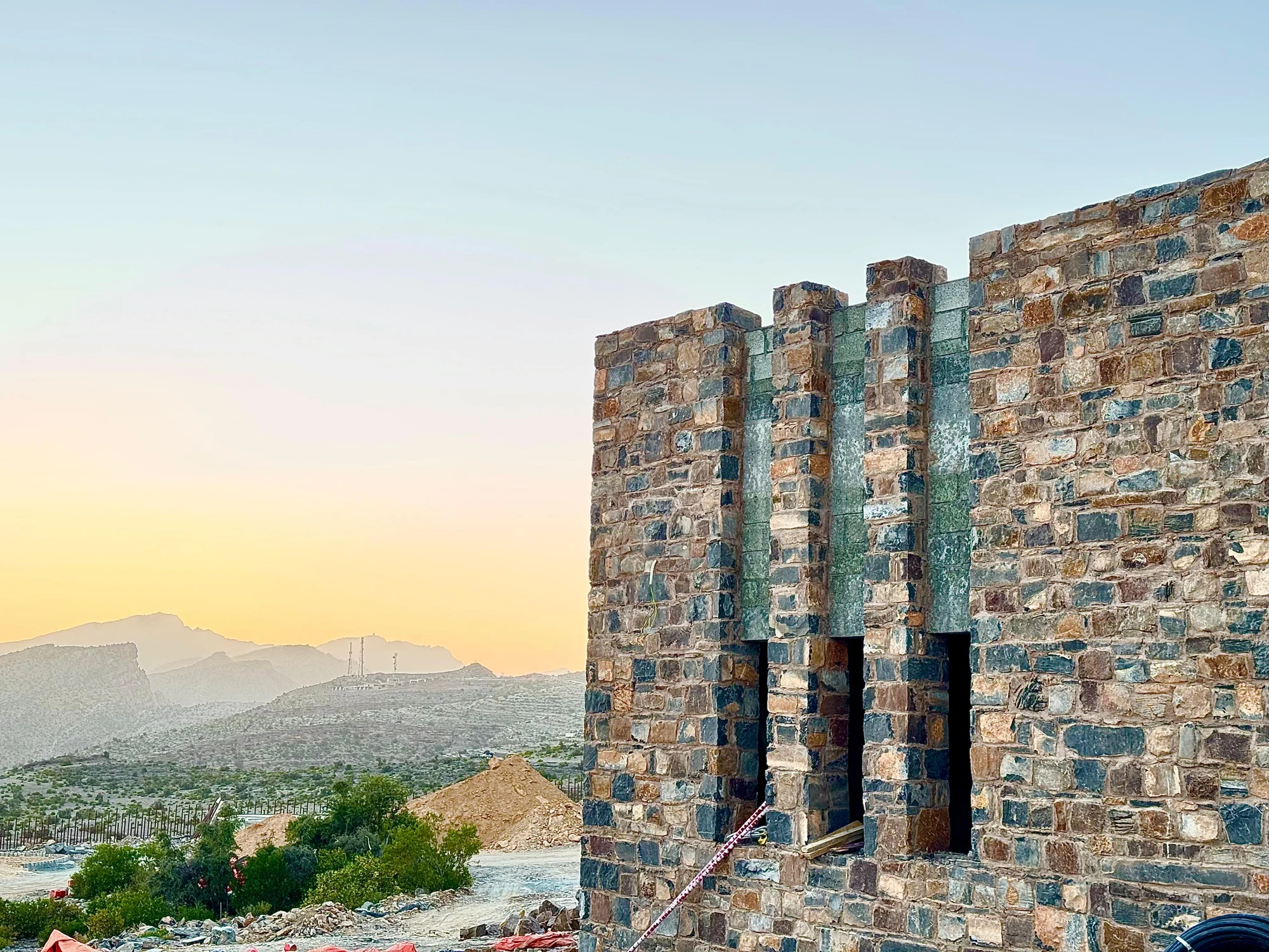 The building and mountain landscape at the Sabaj site